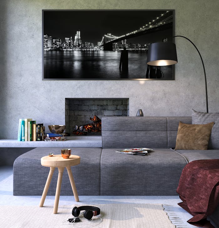 services-06 Modern gray living room featuring a fireplace and cityscape artwork, creating a cozy ambiance.